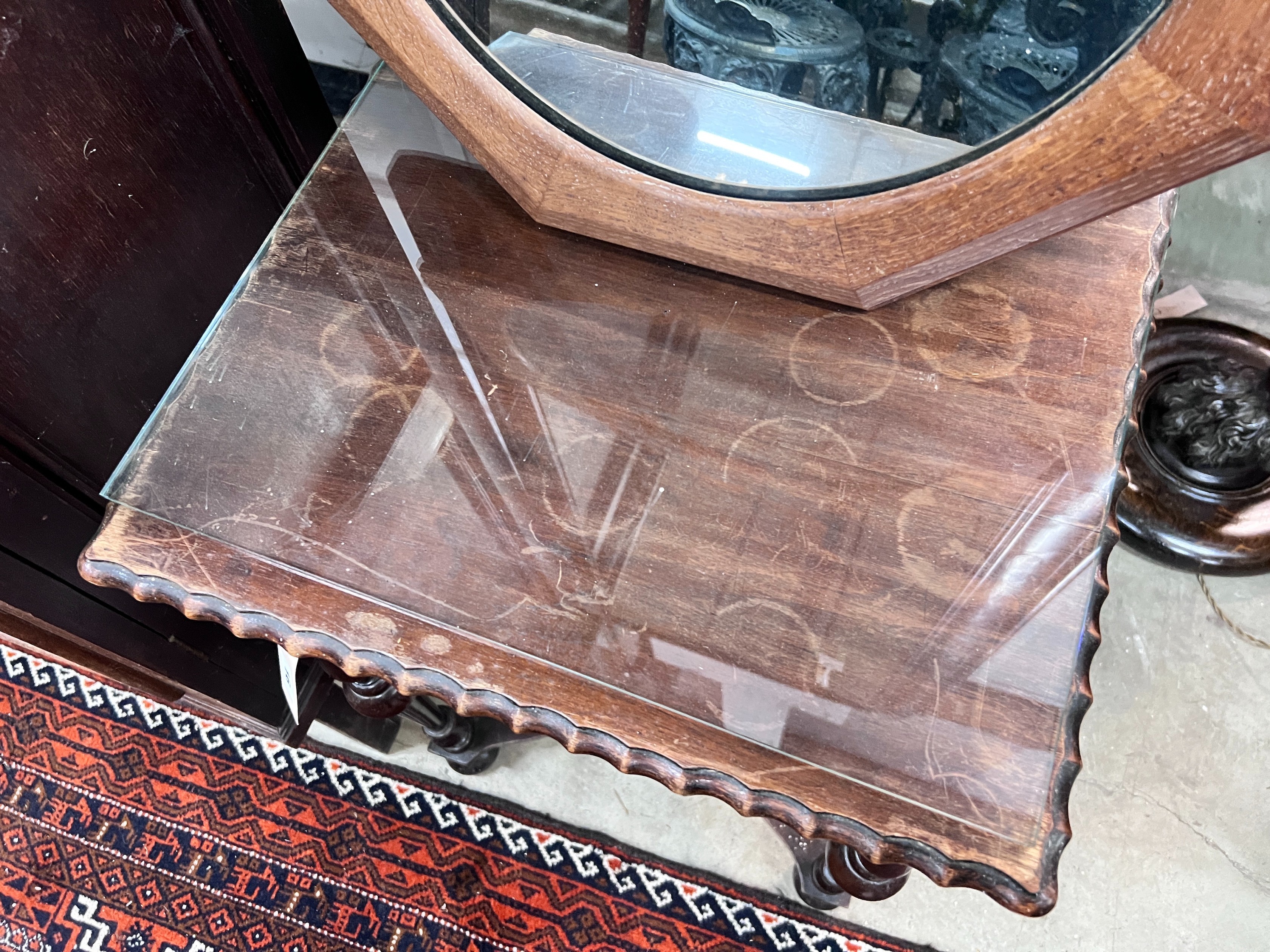 A 1920's mahogany side table, width 45cm, height 70cm, together with an octagonal oak framed wall mirror *Please note the sale commences at 9am.